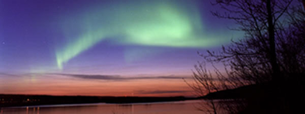Northern lights shining in the night sky near Fort McMurray.